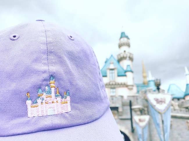 pastel lavender baseball hat with cinderella castle embroidered on it 