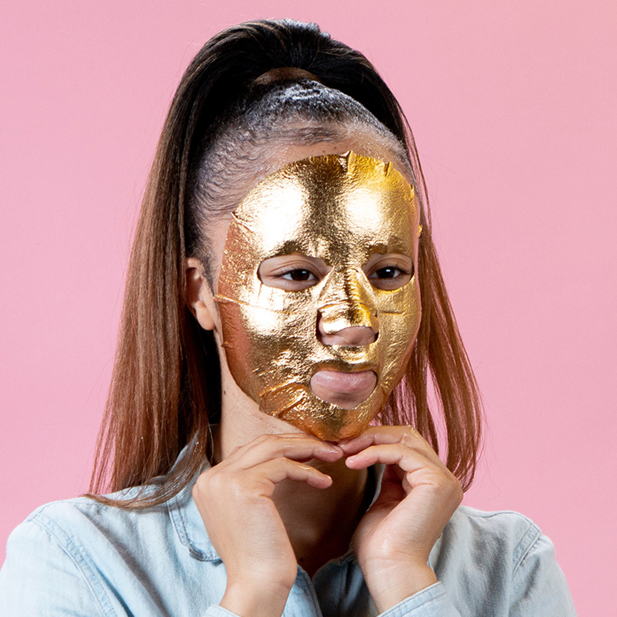 model wears gold foil face mask