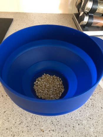 A silicone bowl with popcorn kernels 