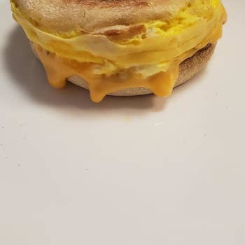 A finished breakfast sandwich with egg and cheese 