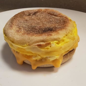 A finished breakfast sandwich with egg and cheese 