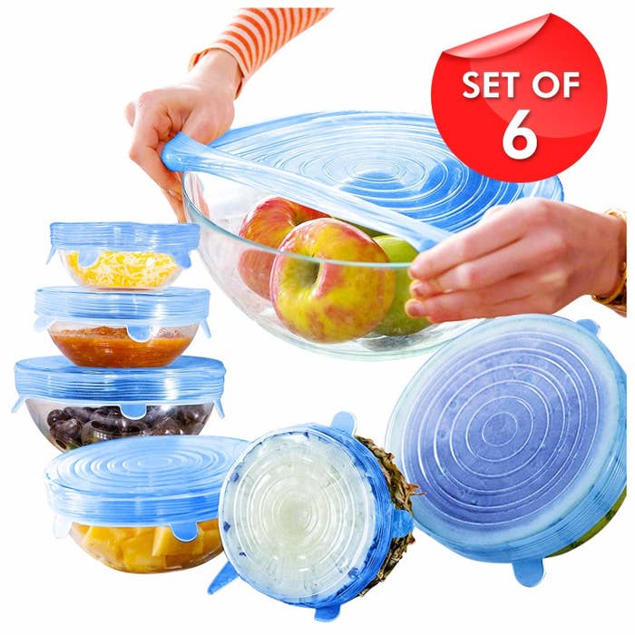 A silicone stretch lid being placed over a bowl of food, and six food bowls of different sizes with stretch lids already on them