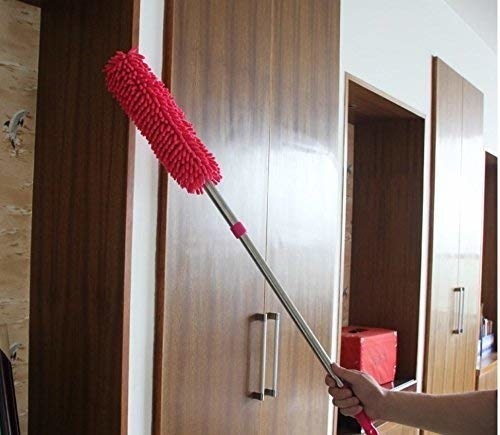 A hand cleaning hard-to-reach cupboard doors with the mop.