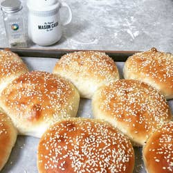 Bread rolls baked with sesame seeds on them 