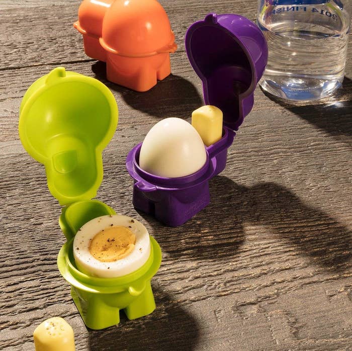 Three egg containers with eggs in them