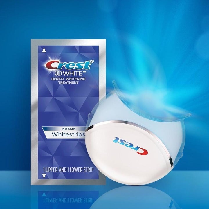 Pack of Crest 3D White Strips next to Crest LED whitening device