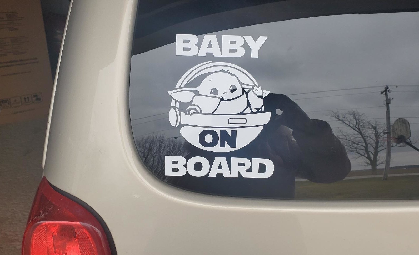 sticker that says baby on board with baby yoda illustrations 