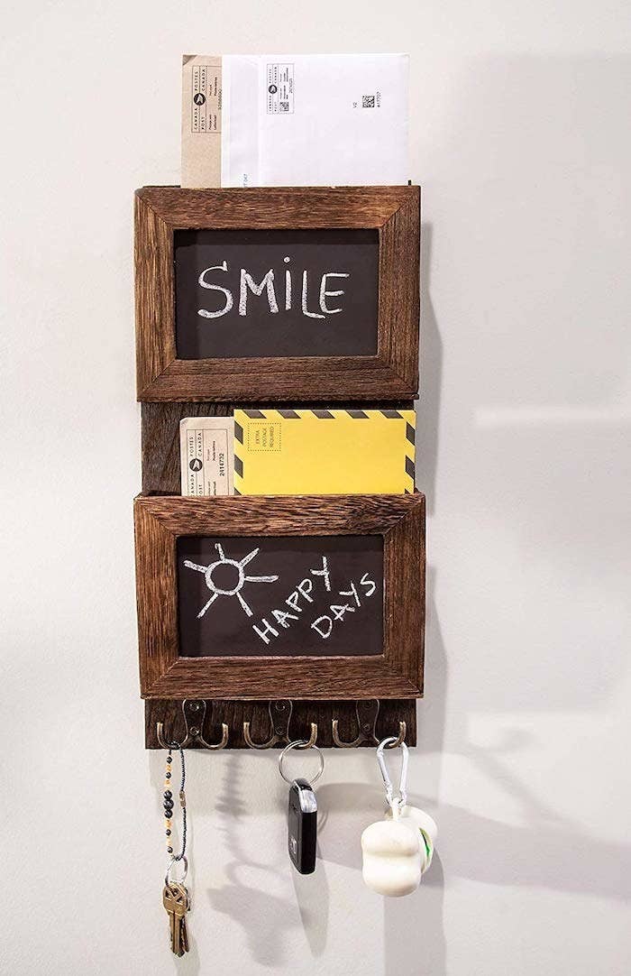 the two teir mail slot with the words smile and happy days written on the chalkboards