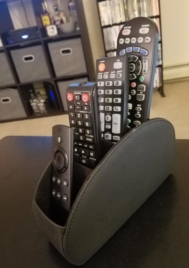 a reviewer&#x27;s photo of the remote organizer filled with remotes