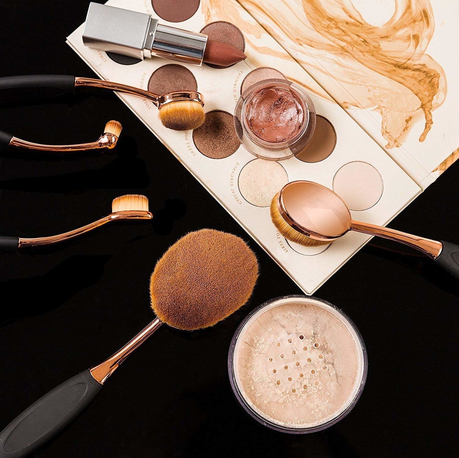 The round makeup brushes with powder, lipstick, and an eyeshadow palette