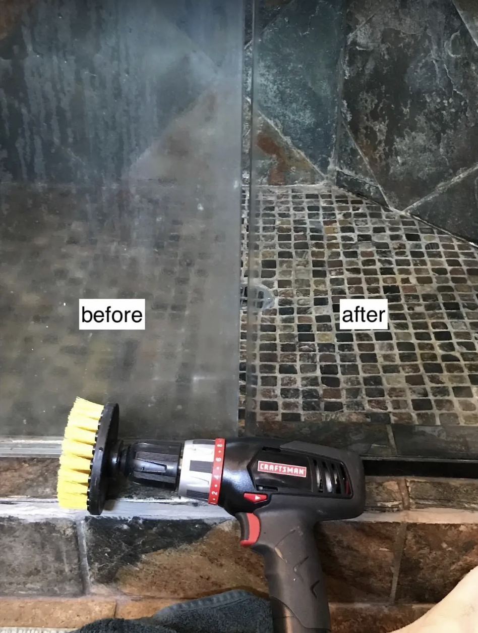 A reviewer&#x27;s drill brush lays in front of two shower glass panels, one unclear and full of scum and the other so clear that it&#x27;s hard to tell there&#x27;s glass there