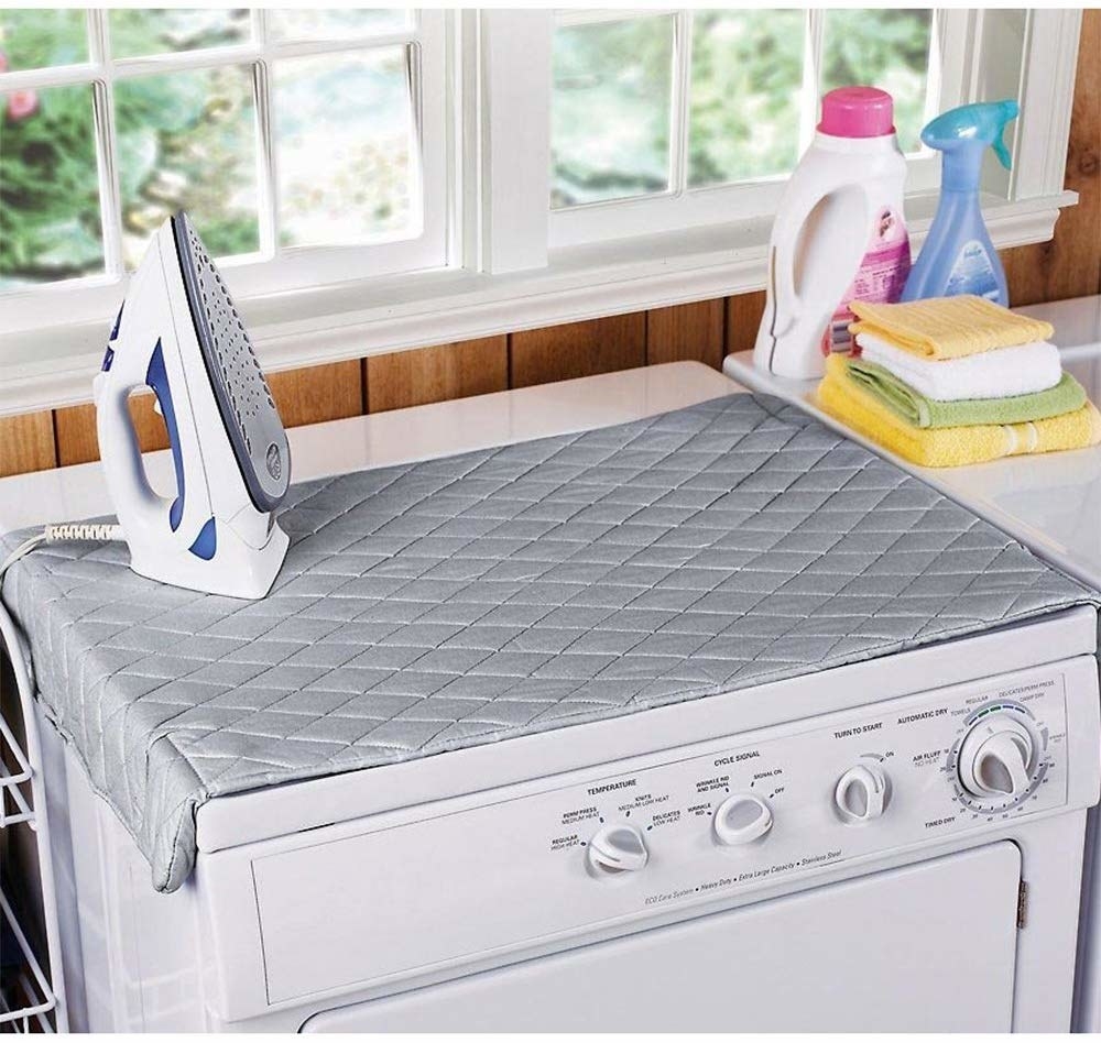 the laundry pad on top of a washing machine