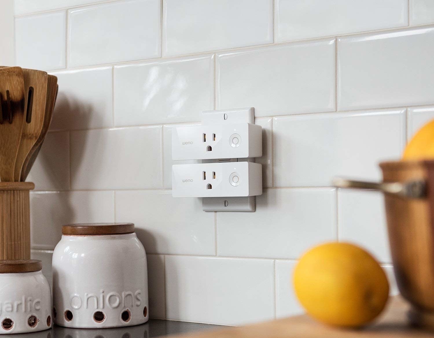 Two smart plugs in a kitchen outlet