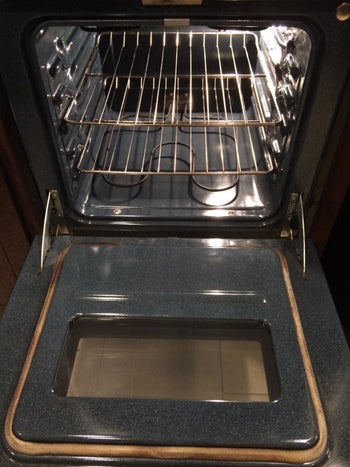 after image of same oven looking shiny and clean