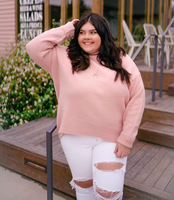 Reviewer wearing the sweater in light pink