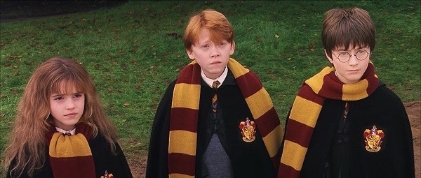 Hermione wearing her scarf folded, Ron wearing his loose, and Harry wearing his wrapped around