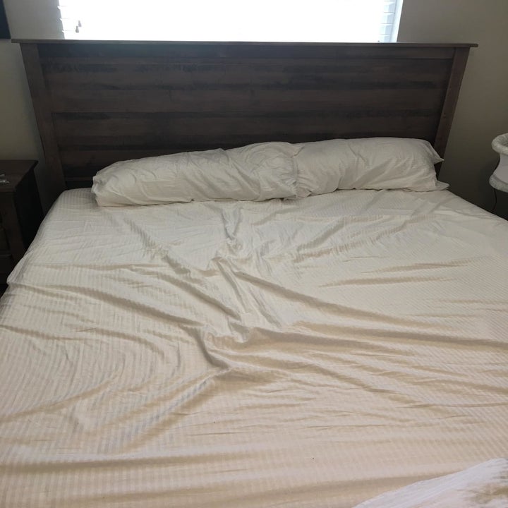 A reviewer image of a bed with messy sheets