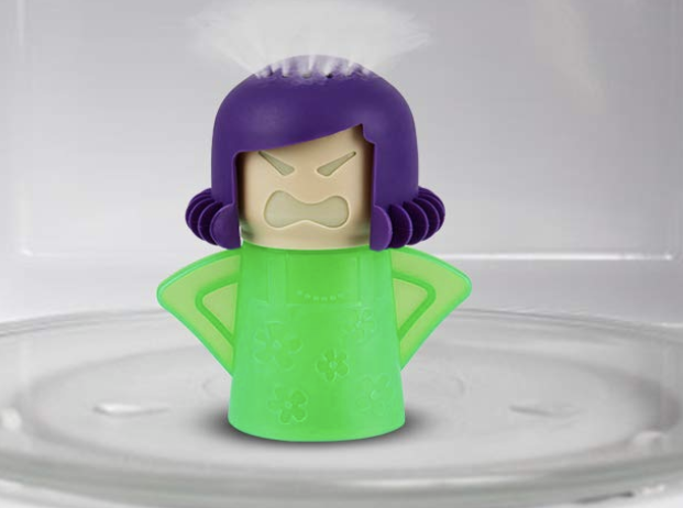 Green and purple &quot;Angry person&quot; cleaner filled with vinegar and steam coming out of the head inside a microwave