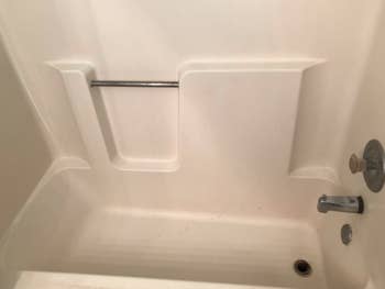 Reviewer's sparkling clean tub after using rust stain remover