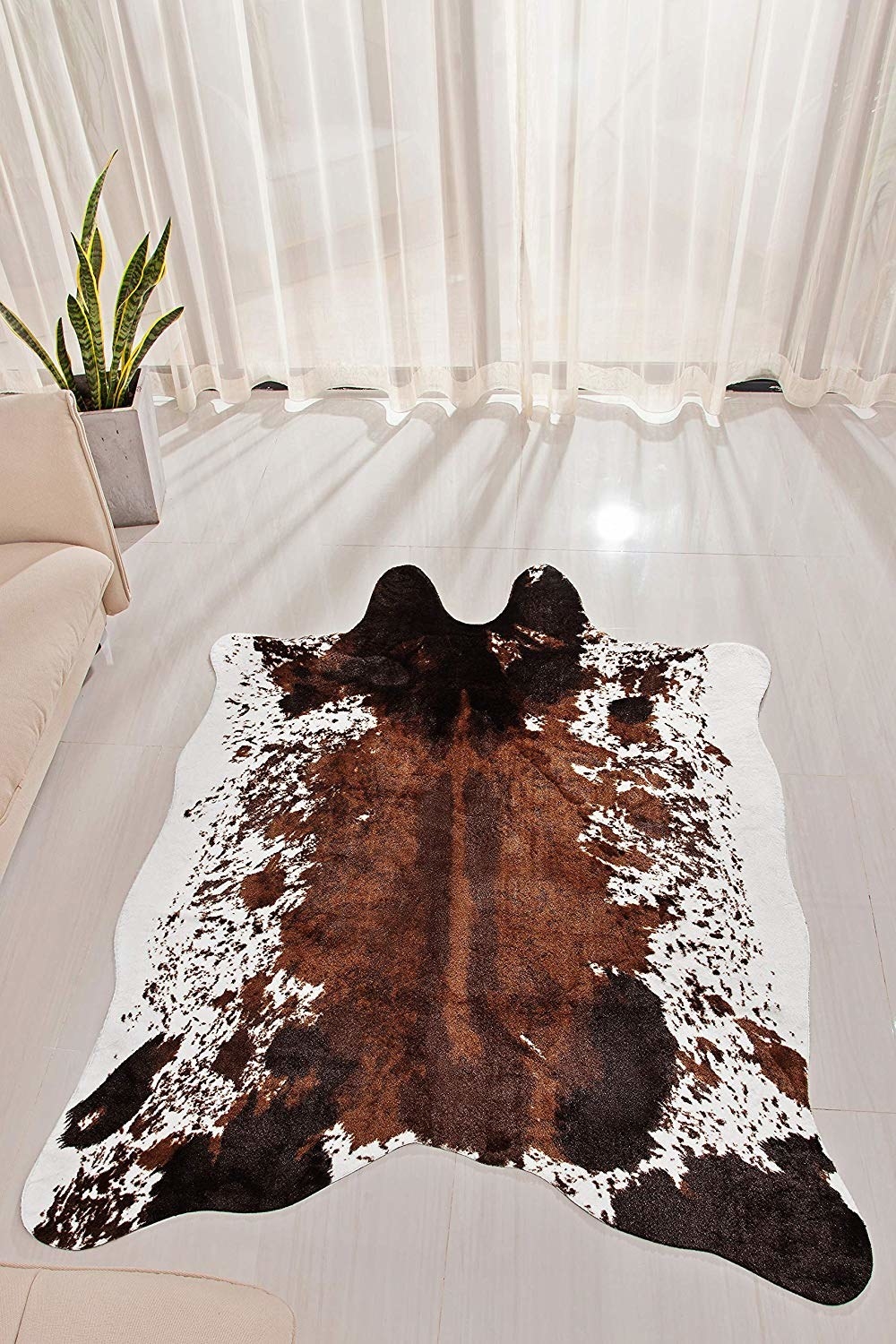 Cowhide rug in white, brown, and tan 