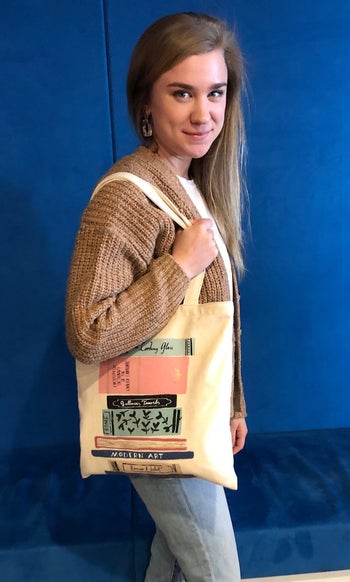 BuzzFeed writer wearing the book tote