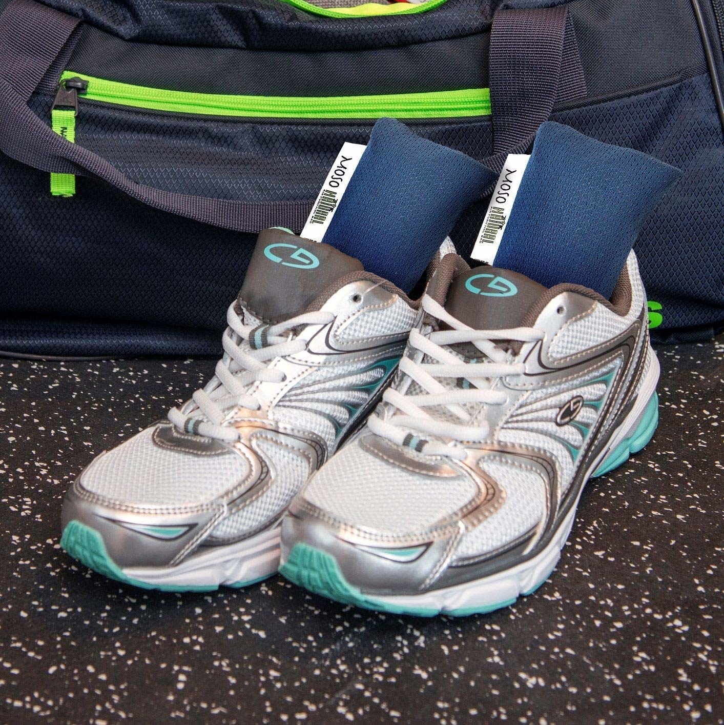 A set of navy blue bean bag deodorizers in a pair of running shoes 