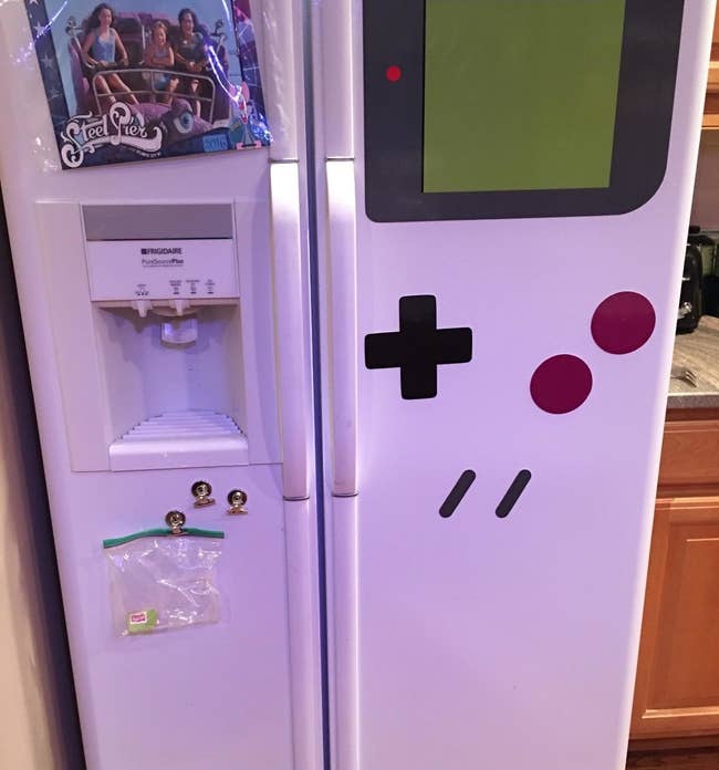 The kitchen magnets arranged to make the side of a fridge look like a game boy