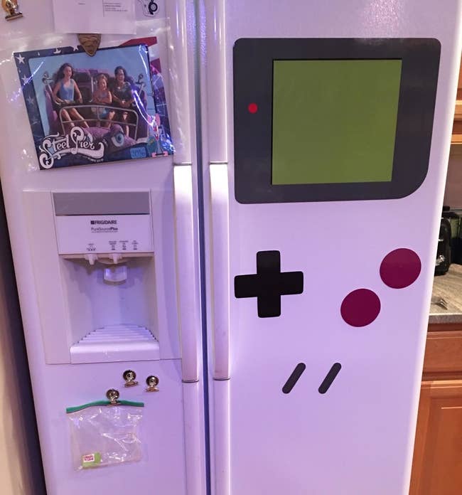 The kitchen magnets arranged to make the side of a fridge look like a game boy