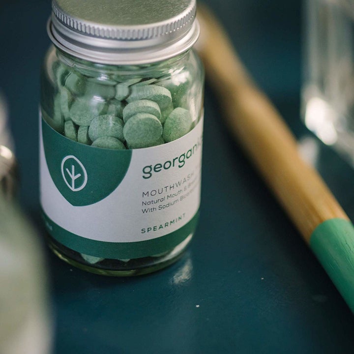 glass jar of green tablets 