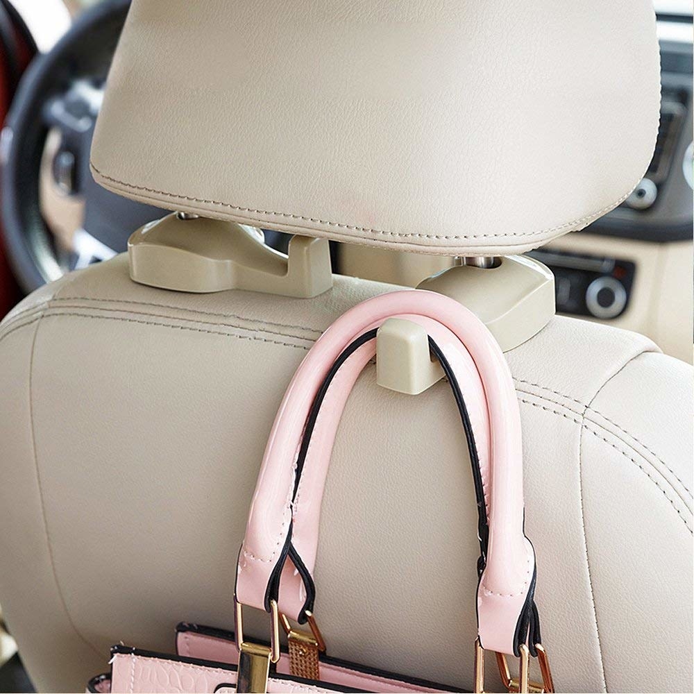 Purse hooked to the back of a car seat with installed beige hook 