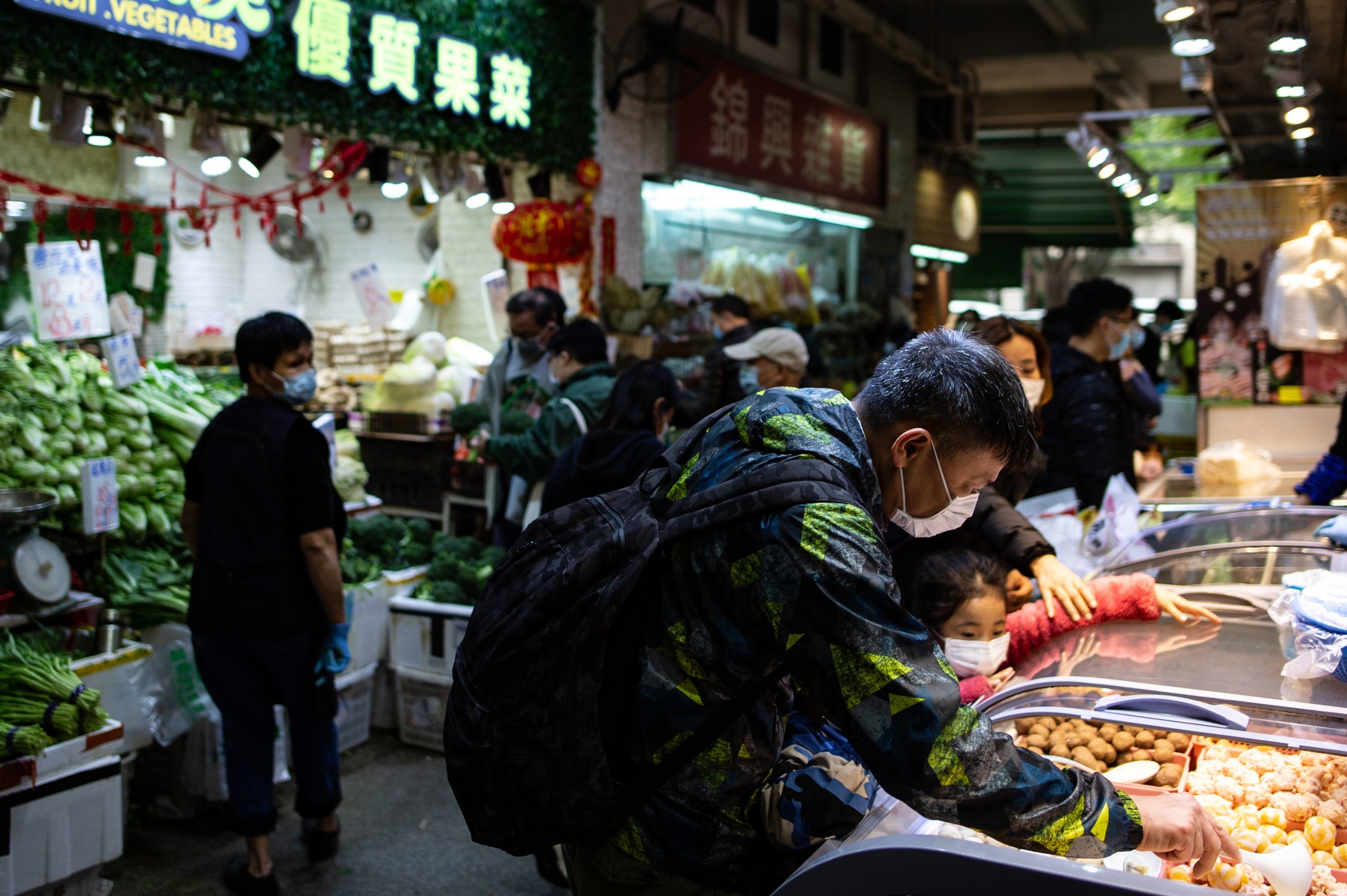 People wearing face masks in a wet market as residents in Mei Foo district.