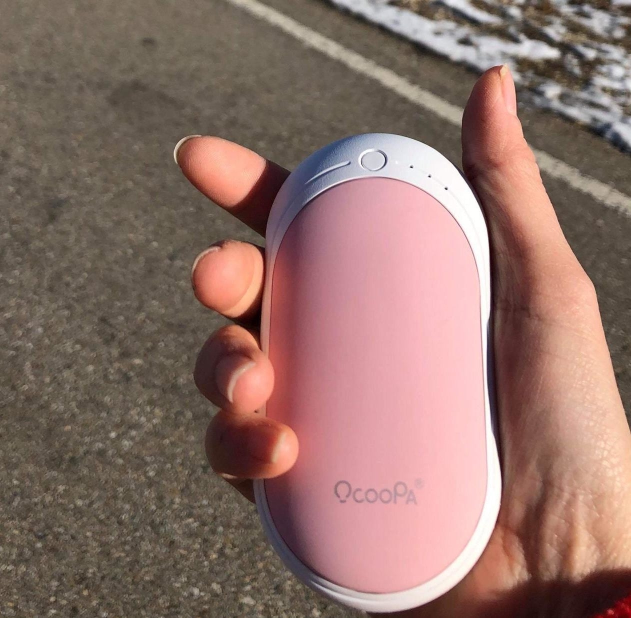 Reviewer holding the hand warmer