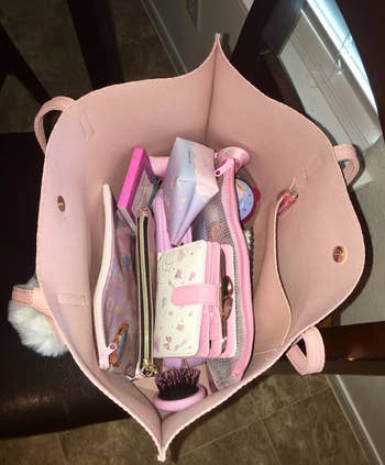 reviewer image of inside pink tote, showing pocket and space for belongings