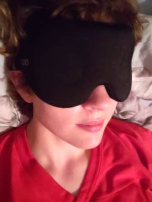 reviewer wearing black sleep mask