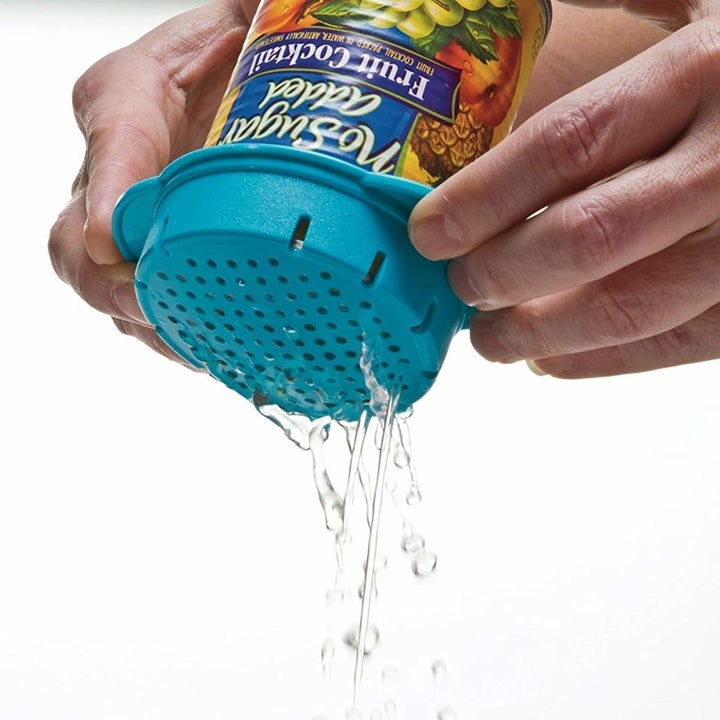 Hands using the small circular product to pour water out of a can