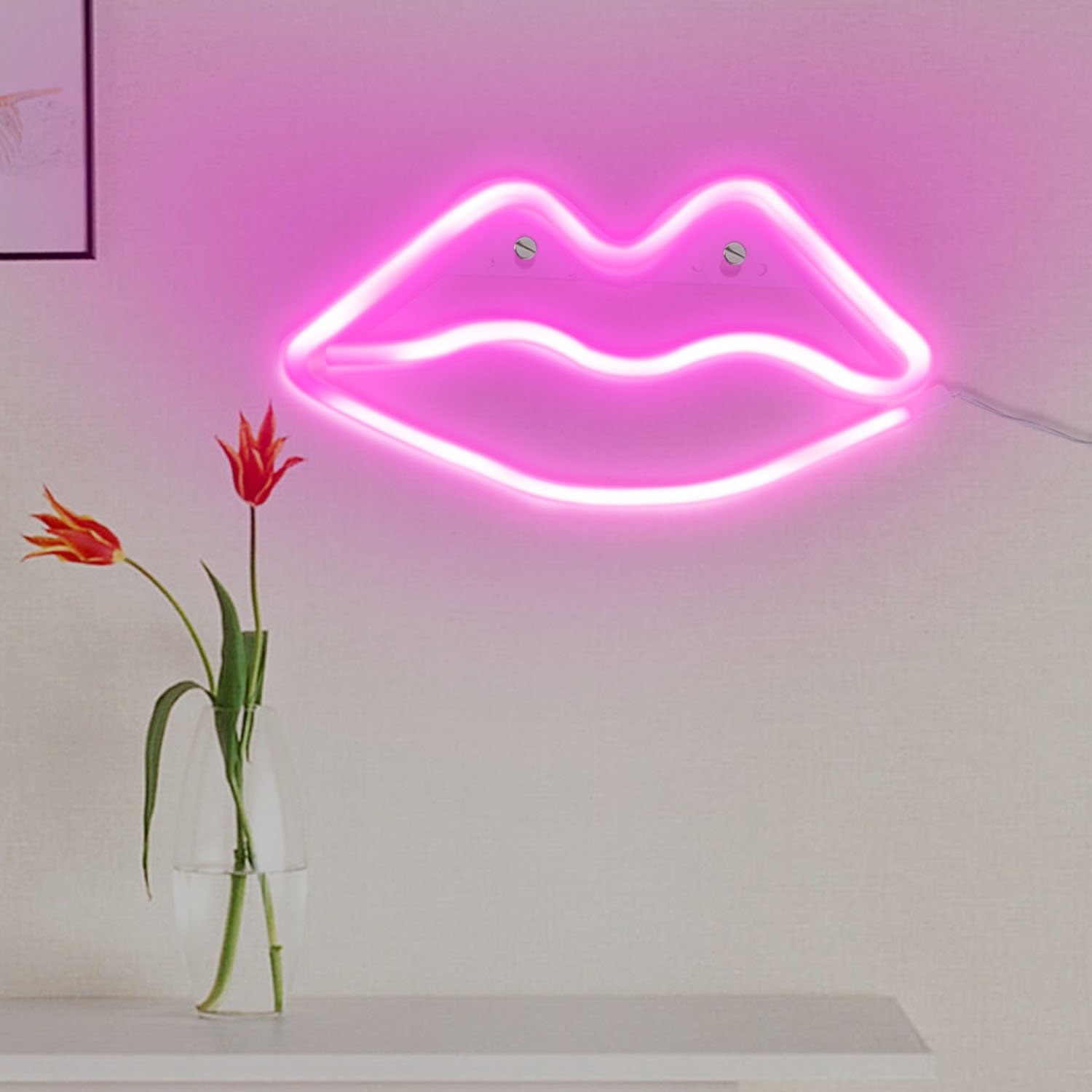 Pink neon lips on a wall