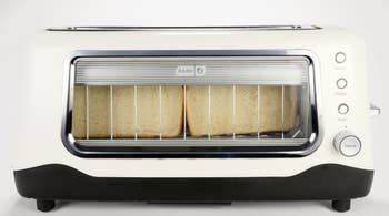 White toaster with glass at sides to show the bread inside 