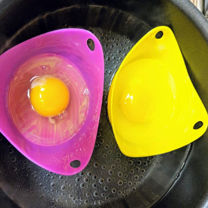 a reviewer photo of two of the poaching cups in a pot of water