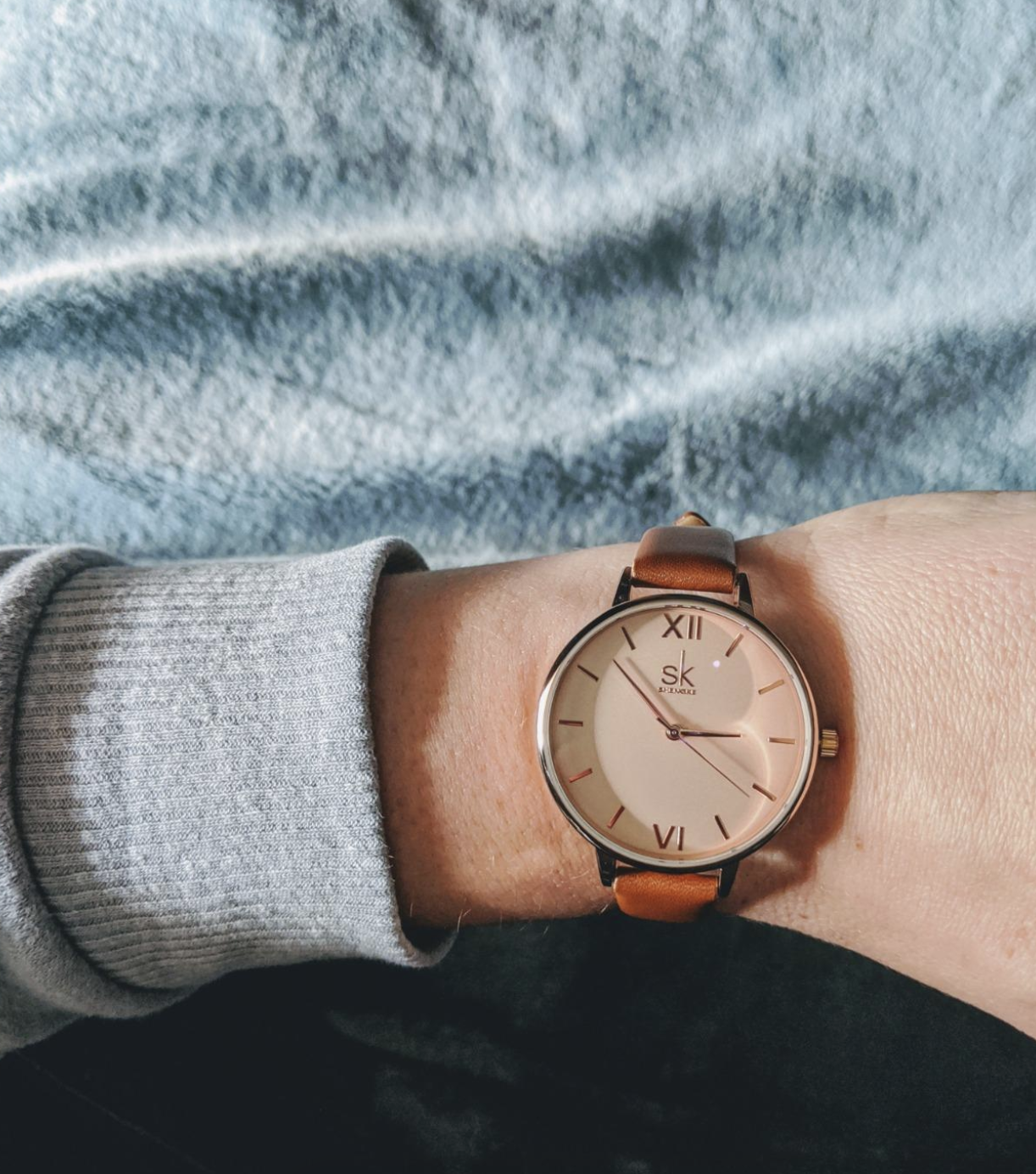 reviewer wearing the rose gold watch