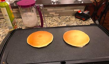 perfectly round pancakes on a griddle