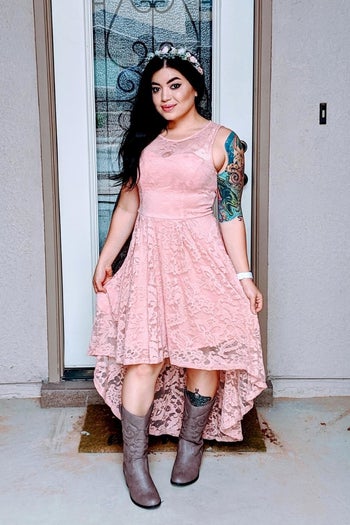 reviewer wearing the dress in pink with boots 