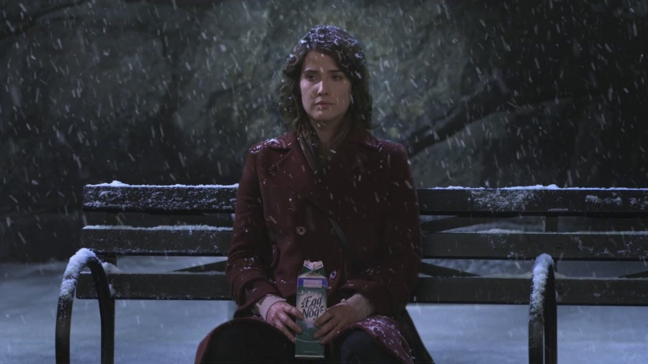robin sitting on a bench with egg nog