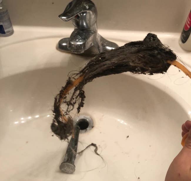 Reviewer photo showing a large clump of hair pulled out from the sink drain