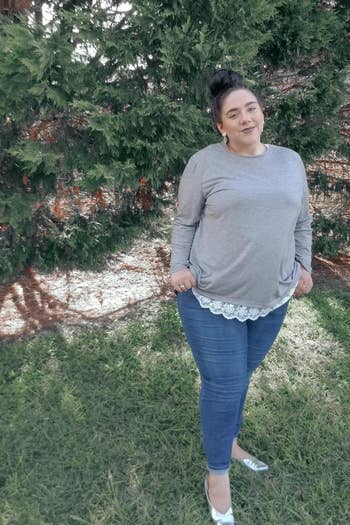 reviewer wearing the top in gray with white trim 