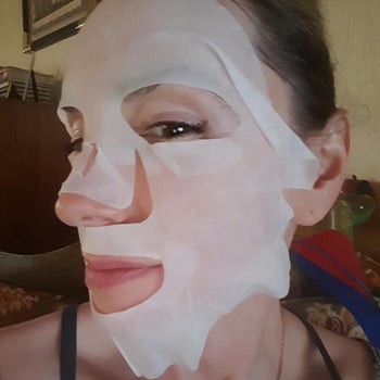 reviewer with a white face mask on 