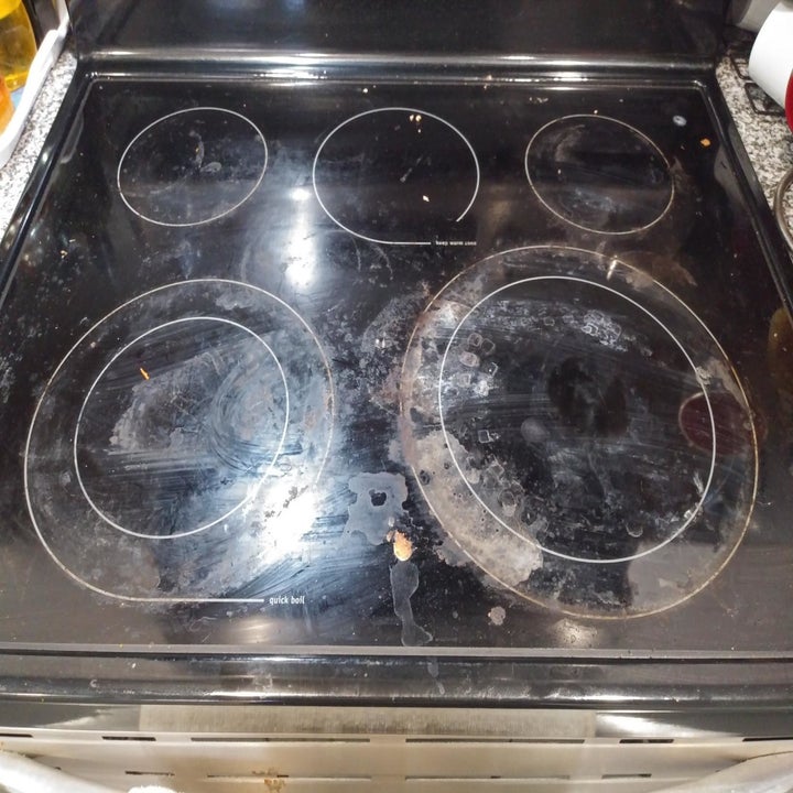reviewer photo showing their electric stovetop covered with grease and streaks 