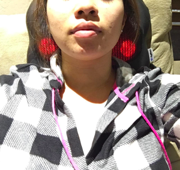 a reviewer using the massager on their neck