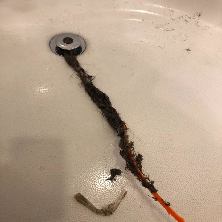 reviewer photo of the drain snake pulling out gunk from a drain