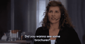gif of Toula from &quot;My Big Fat Greek Wedding&quot; saying, &quot;Did you wanna see some brochures&quot;
