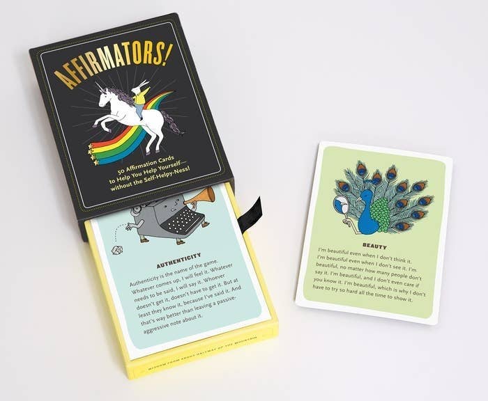 the box of affirmation cards next to an authenticity card and beauty card